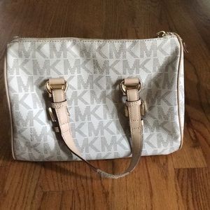 A white logo micheal kors purse with tan handles
